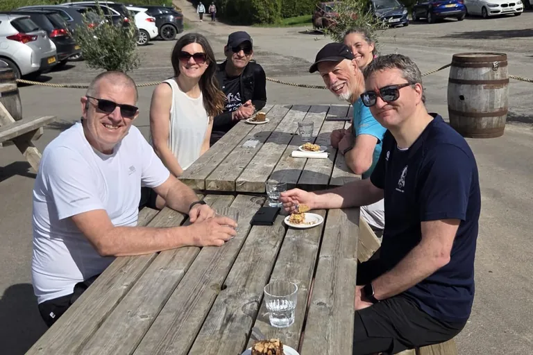 CRWC members enjoying a cafe stop together at an outdoor table