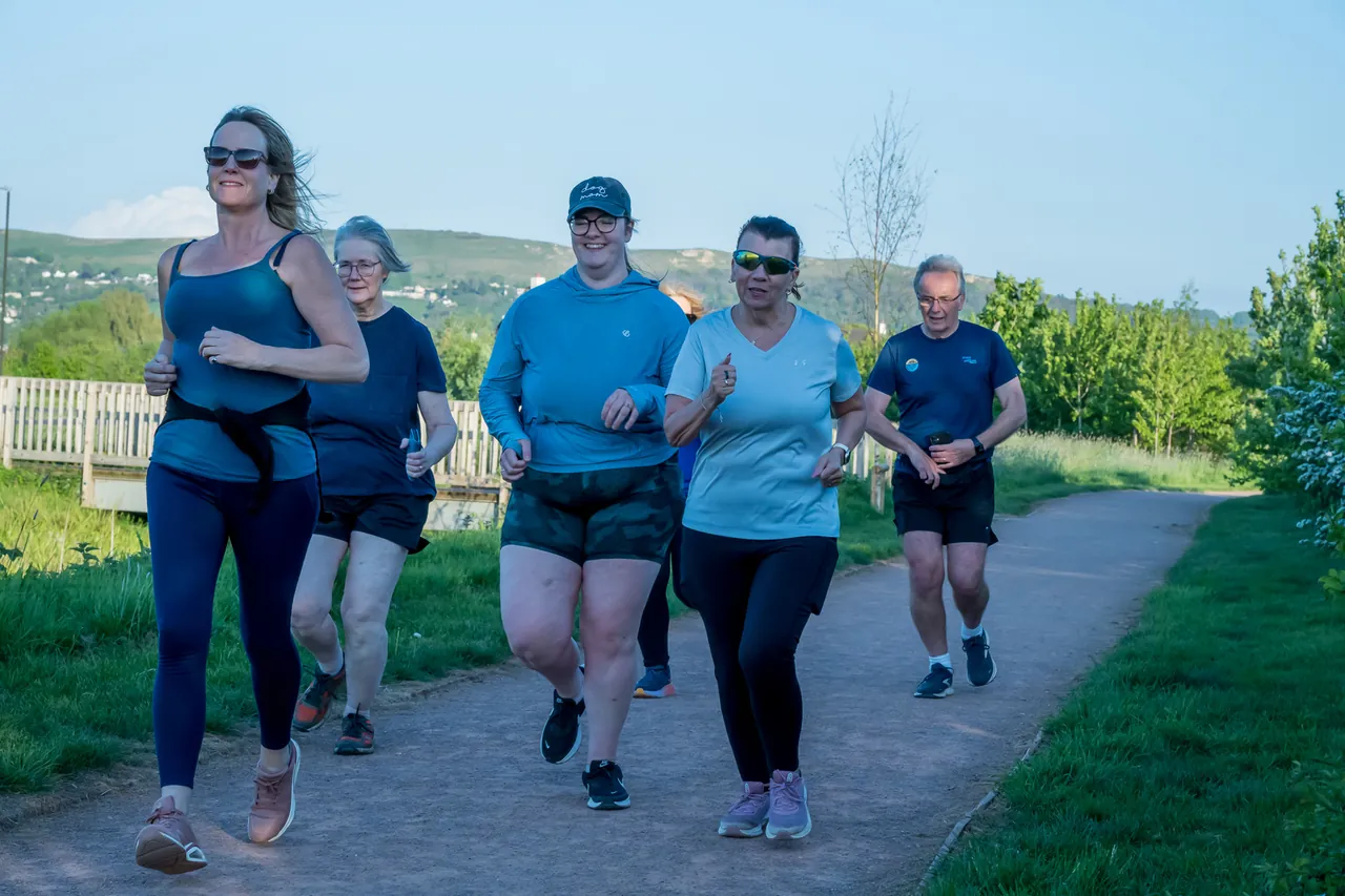 CRWC members jogging together along a green path